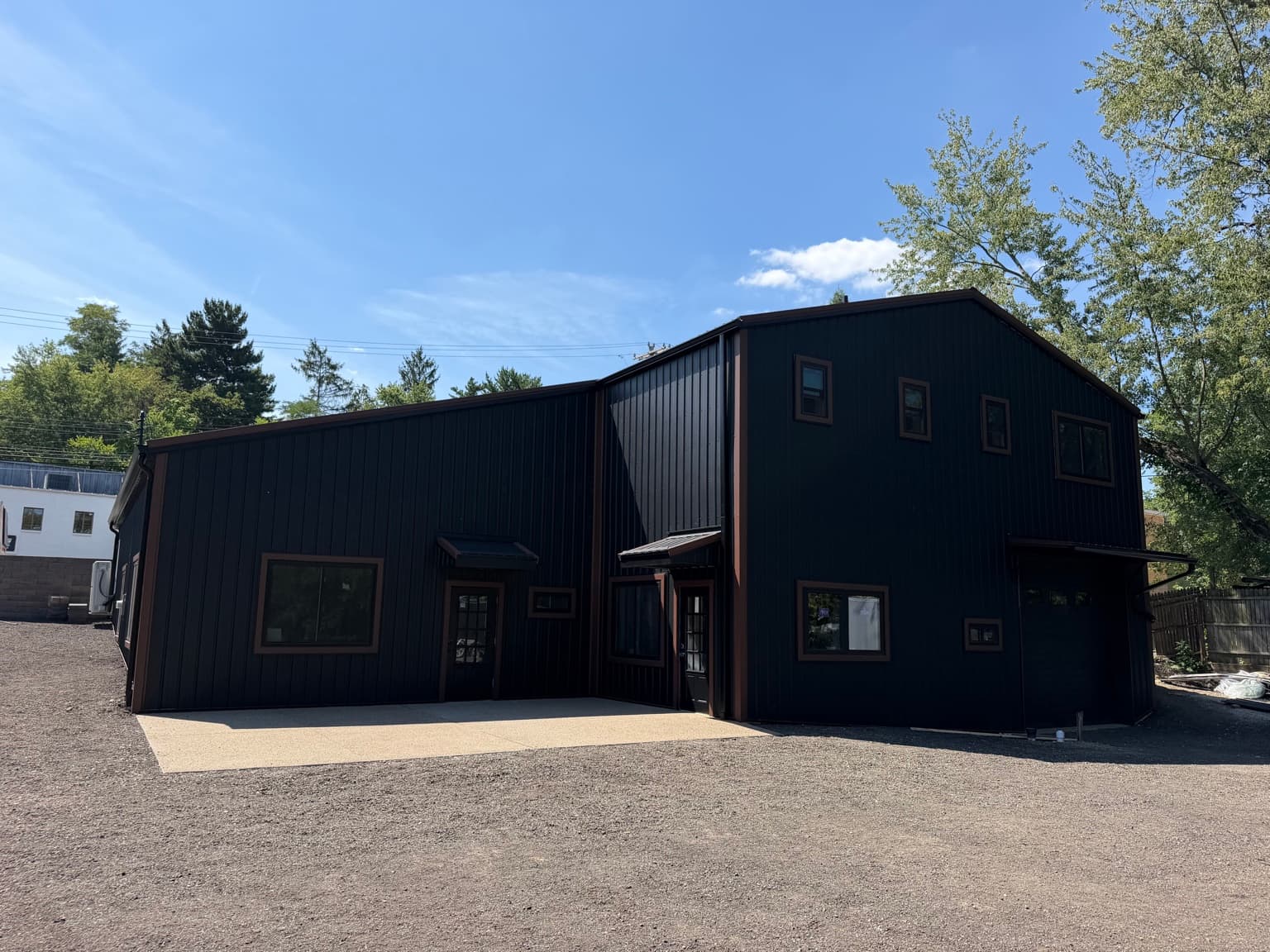 Completed black metal roofing and vertical metal siding by Heritage Build Group