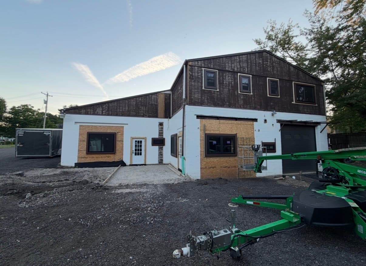 Building exterior before metal roofing and siding renovation