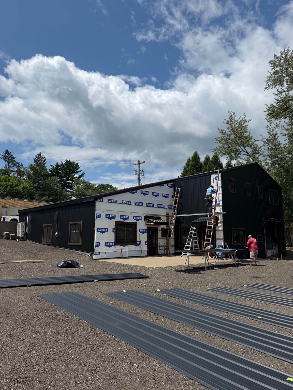 Metal siding panels staged during installation