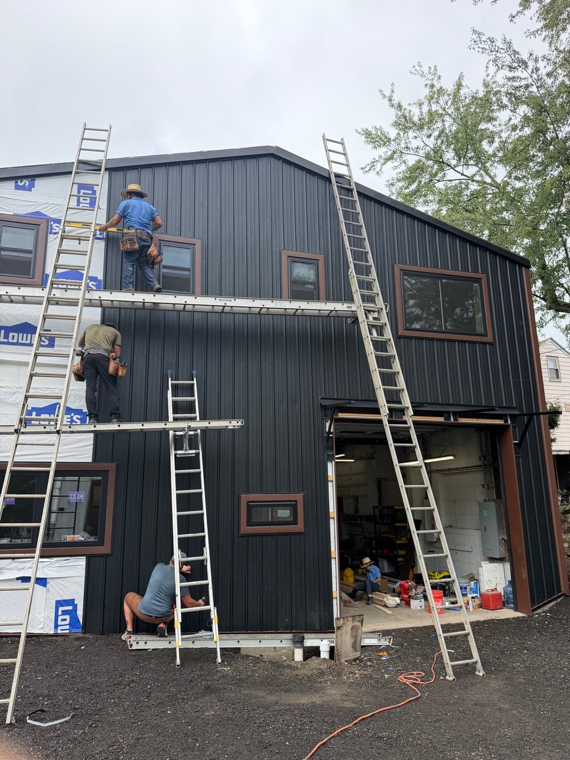 Installation crew working on the metal exterior